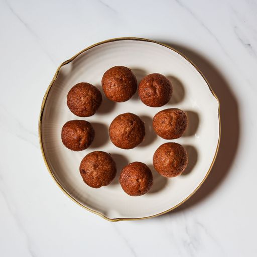 A top view of a white plate with homemade delicious brown muffins