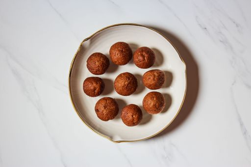A top view of a white plate with homemade delicious brown muffins
