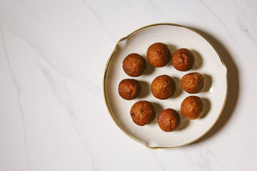 A top view of a white plate with homemade delicious brown muffins with copy space