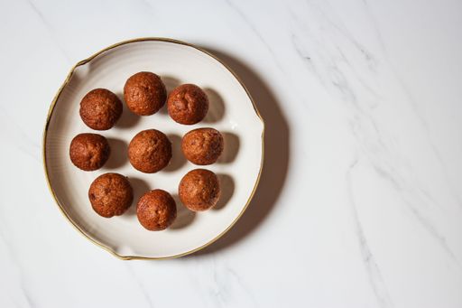 A top view of a white plate with homemade delicious brown muffins and copy space