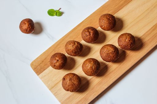 A top view of a wooden board with homemade delicious brown muffins