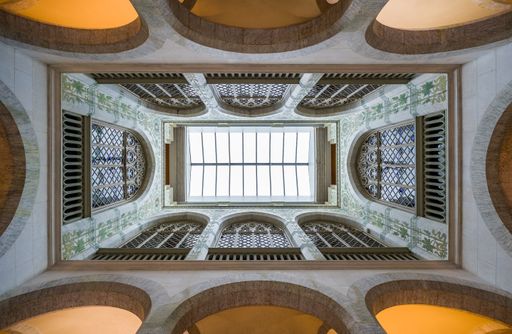 A low angle shot of the inside of an old building with geometrical walls and domes