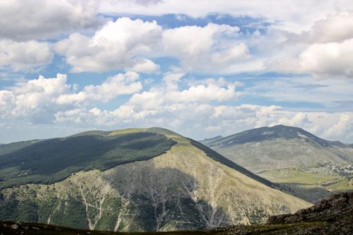 A mesmerizing view of a beautiful mountainous landscape against a cloudy sky