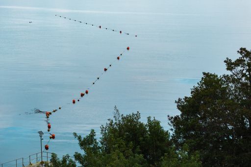 A high angle shot of the sea captured from the beach during the daytime