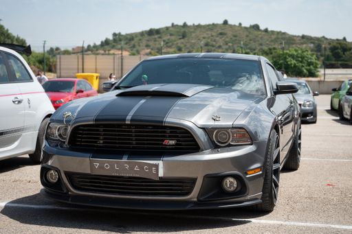 A gray fifth generation Boss 302 Ford Mustang parked at an exhibition
