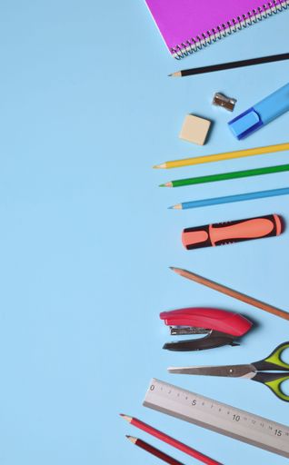 An assorted school supplies scattered on the blue background