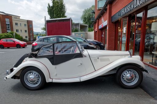 A side view of the MG TF 1500 Roadster parked in a parking slot of local shopping center in Bray, Ireland. Classic sports car from 1950s.