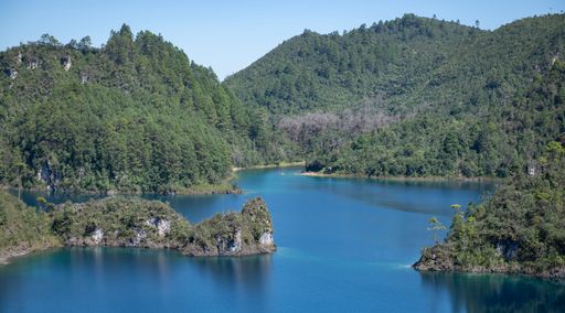 The pine forests in front of Lake Tziscao with a blue sky in the background, Chiapas,  Mexica