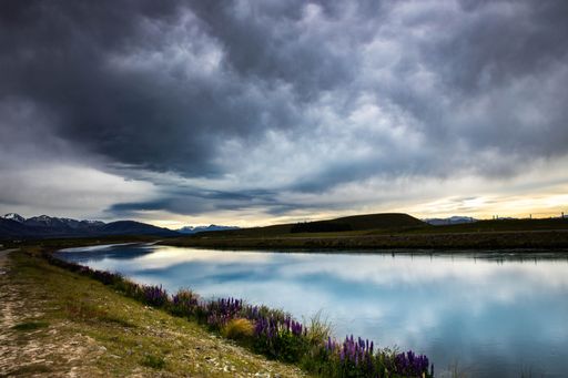 A scenic view of the calm Twizel river in New Zealand during sunset