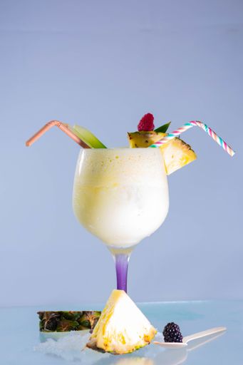 A vertical shot of a traditional Caribbean pina colada cocktail with rum, coconut milk and pineapple juice