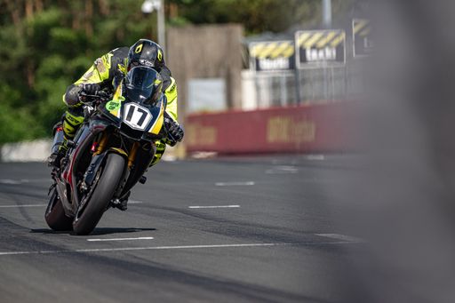 A motorcyclist riding on a motorbike on the road in daylight