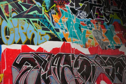 A vertical closeup shot of a colorful legal public graffiti wall on Tesnov Street in Prague, Czech Republic