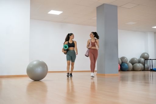 TWO GIRLS TRAINING YOGA AND PILATES TOGETHER WITH A BALL AND WEIGHTS very happy