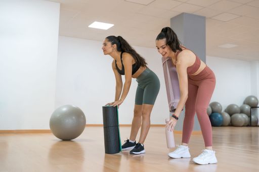 TWO GIRLS TRAINING YOGA AND PILATES TOGETHER WITH A BALL AND WEIGHTS very happy