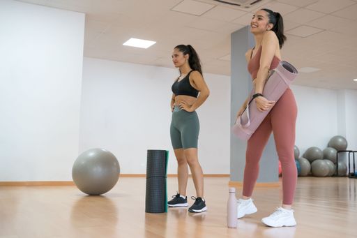 TWO GIRLS TRAINING YOGA AND PILATES TOGETHER WITH A BALL AND WEIGHTS very happy