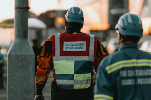A back view of coastguard rescue officers wearing helmets