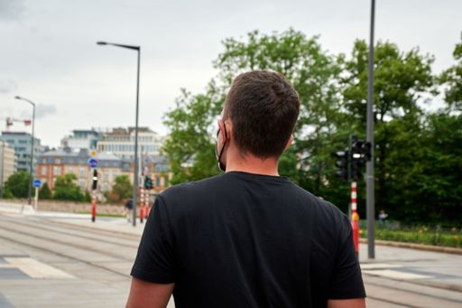 A back shot of a man in front of a crossroad