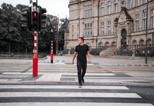 A man crossing a street in front of State Savings Bank, Luxembourg