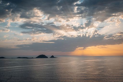 A beautiful shot of a sunset over the beach in L'Ile Rousse in Corsica, France
