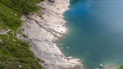 An aerial shot of the coast of the Lake Aussois in France on a sunny day