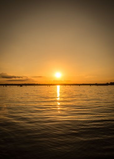 A vertical shot of the scenic sunset over the sea, perfect for backgrounds