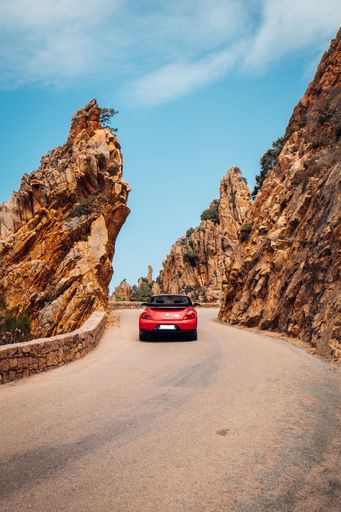 A vertical shot of a car on the road in Calanques Corsica, Piana, France