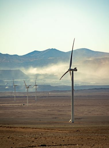 A vertical shot of windmills in the Atacama Desert, Chile under blue sky