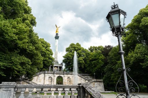 The Angel of Peace monument in Munich, Germany under the dark cloudy sky