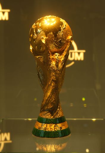 A vertical shot of the Fifa World Cup trophy displayed to the crowd in Zurich, Switzerland