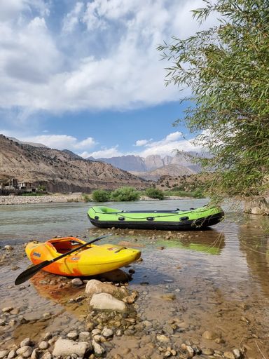 A vertical shot of kayaks on the Armand river shore