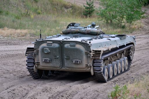 A Panzer BMP 1 Sowjetisch DDR driving to the muddy road