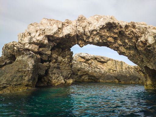 A beautiful shot of stone formations over the water at the Tremiti Islands in Puglia, Italy