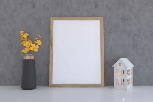 A 3D rendering of a mockup frame, flower vase and a small house near a gray wall