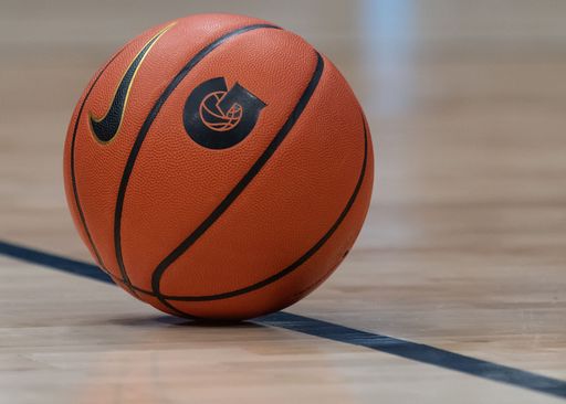 A closeup shot of the basketball ball in the indoors field