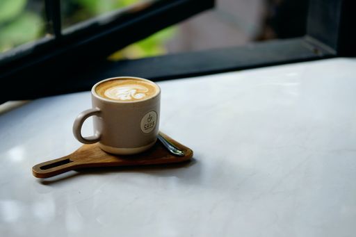 A cup of Latte art on a white surface