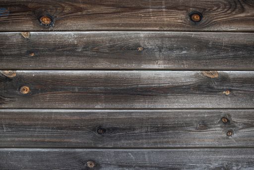 Old brown wood background made of dark natural wood in grunge style. The view from the top. The surface of the table to shoot flat lay. Copy space
