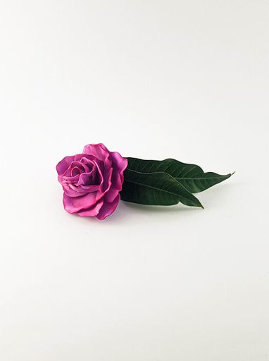 A vertical shot of artificial pink rose isolated on white background