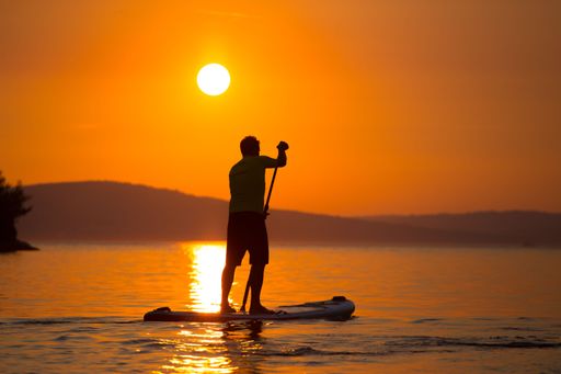 A breathtaking view of a silhouette of a man sailing on a SUP at golden sunset, Brac Island, Croatia.
Perfect for a background.