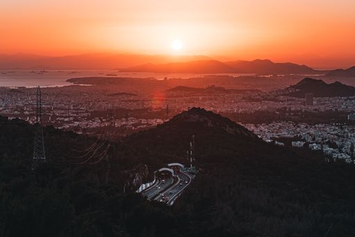 A big golden sunset over the city of Athens and the Attiki Odos road in Greece