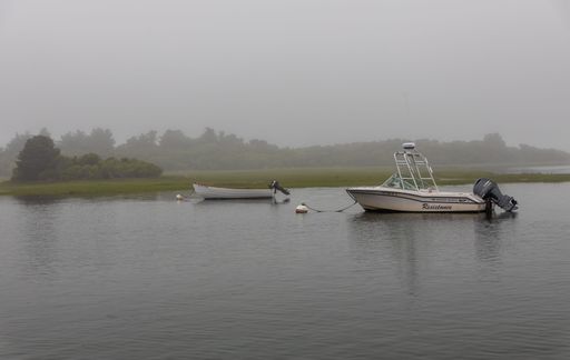 A few boats on a foggy morning