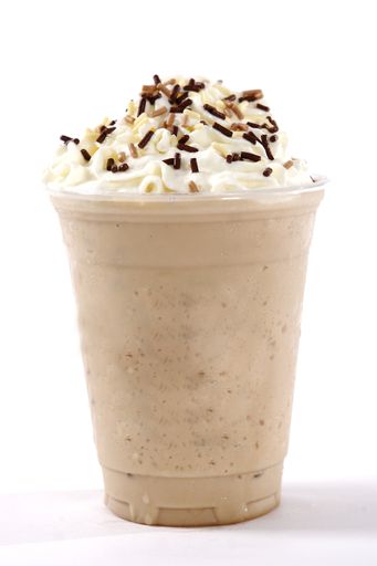 A vertical shot of icy cappuccino with whipped cream and sprinkles on top