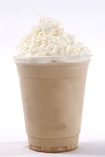 A close up shot of delicious creamy chocolate cold milkshake with whipped cream on top