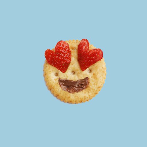 A close up shot of a strawberry chocolate cookie with a lovely emoji face