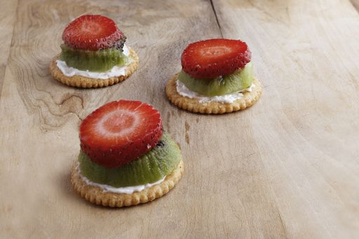 A close up shot of  strawberry kiwi cookies on a wooden surface