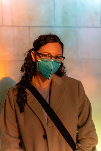 A beautiful shot of a woman wearing a face mask and glasses under the sunlight