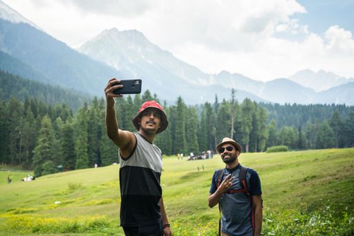 Man Taking selfies in Baisaran Valley( Mini Switzerland) Pahalgam, Kashmir, India.