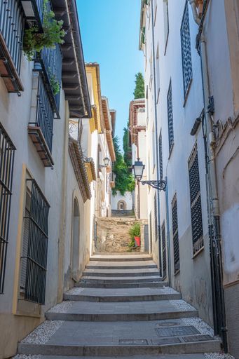 A narrow and pedestrian alley in the city of Granada, Spain