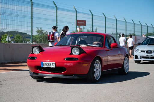A front view of a red convertible Japanese Mazda Mx-5 Miata sports car