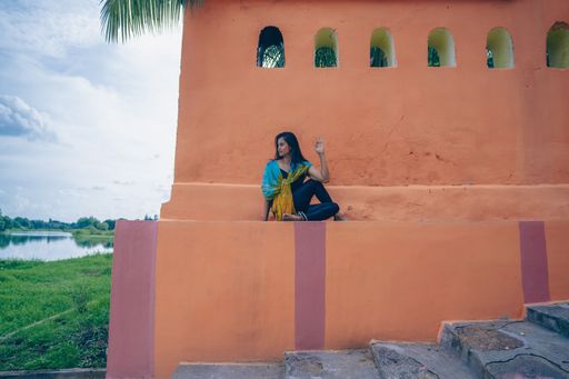 A south asian yogini doing asana in an ancient temple.