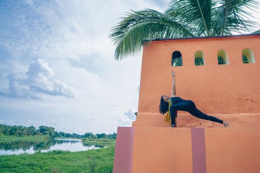 A south asian yogini doing asana in an ancient temple.